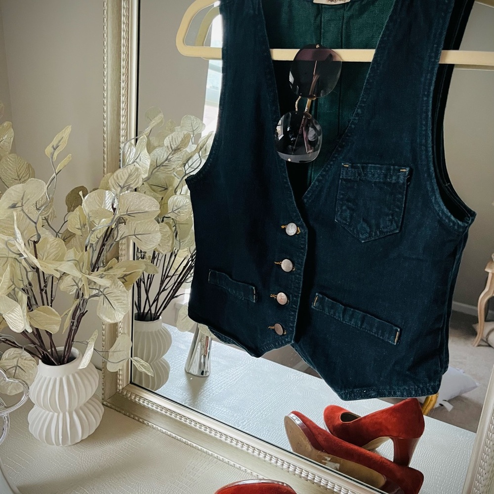 Jean vest with brass color buttons.